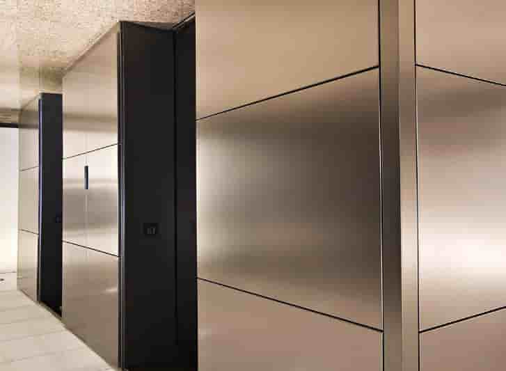 A hallway adorned with stainless steel panels.