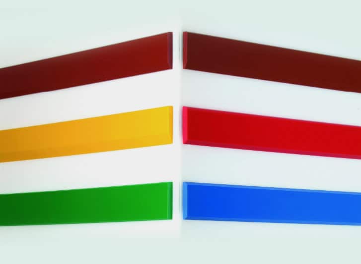 A set of colored plastic strips, featuring a foam corner and wall guard, on a white surface.
