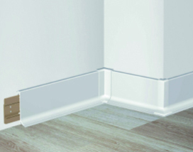 A corner of a room with wooden flooring, enhanced by PVC Corner & Wall Guard Protection Solutions from Warrior WPS.