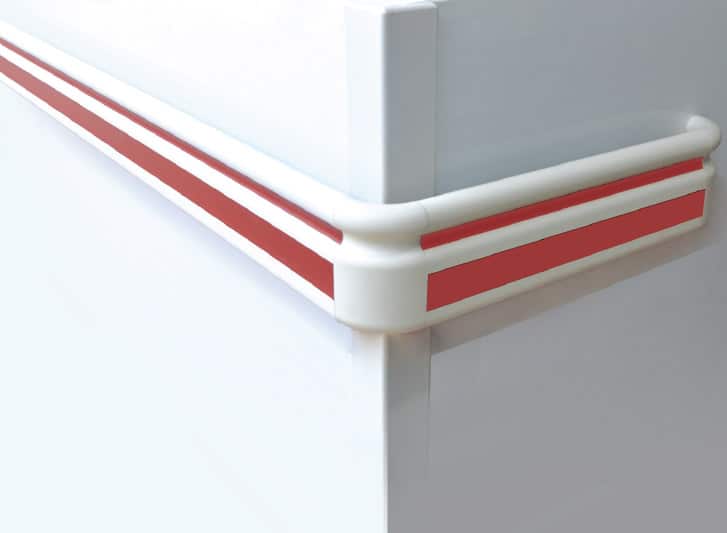 A white and red stripe on the side of a refrigerator, protected by PVC wall guards.