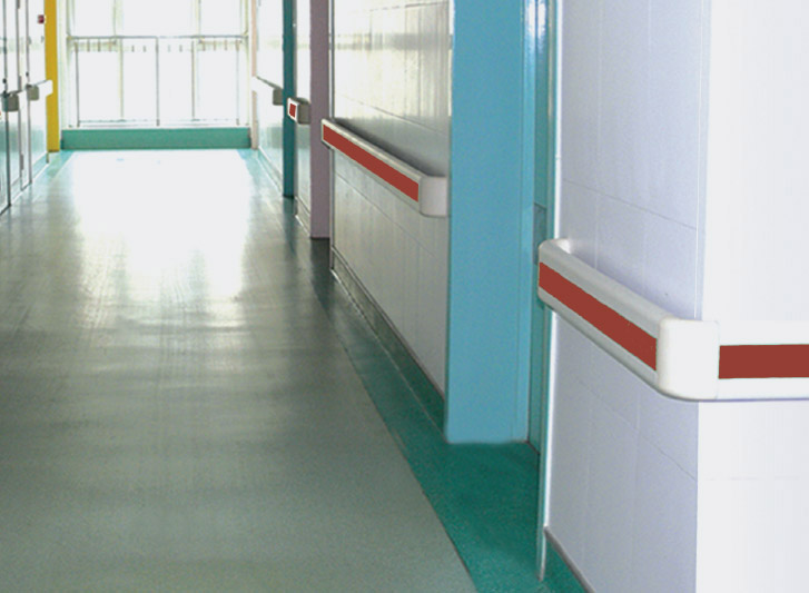 A hospital hallway with pvc hand rails.