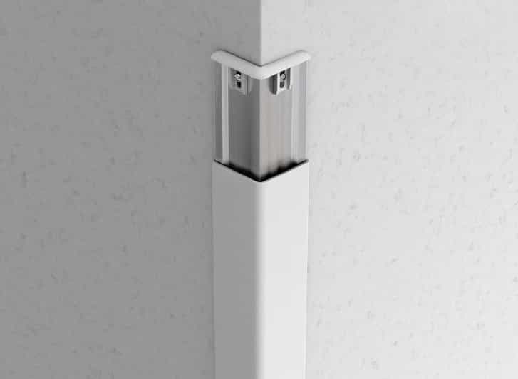An image of a white corner bracket used for PVC wall guards and handrails.