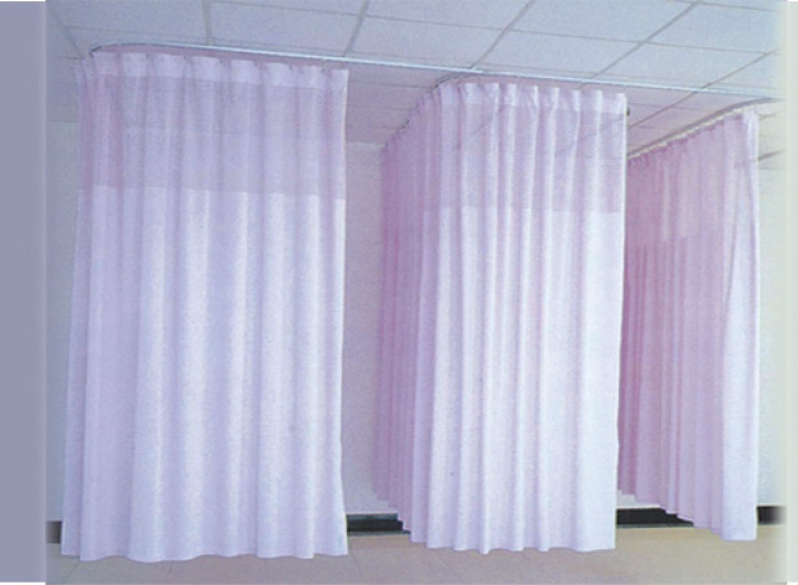A group of pink curtains hanging from curtain rails in a room.