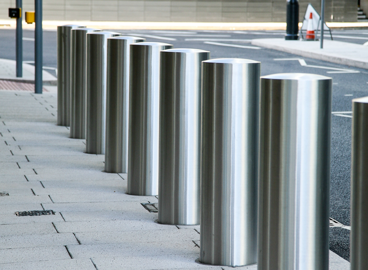A row of stainless steel bollards.