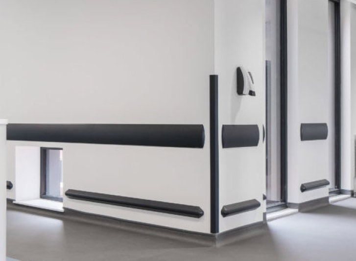 A hospital room with black and white PVC Wall Guards for Hospitals.