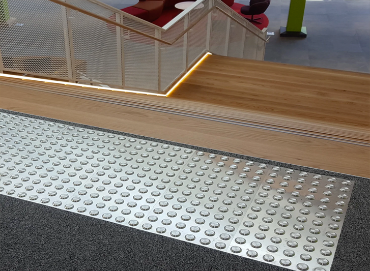 A stairway with stainless steel stair treads.