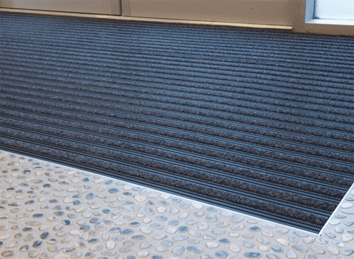 An entrance mat with a black stripe on it is available in both aluminium and PVC materials.